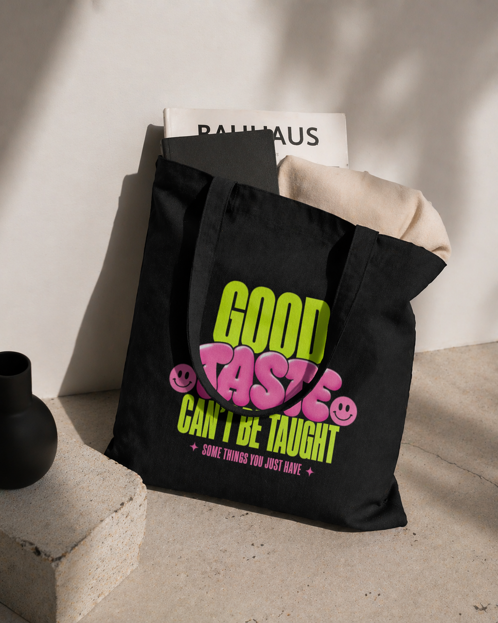 product lifestyle view black tote bag with books and clothing inside good taste cant be taught graphic streetwear