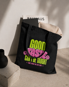 product lifestyle view black tote bag with books and clothing inside good taste cant be taught graphic streetwear