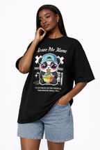 Woman wearing oversized black streetwear graphic t-shirt with panda eating noodles Leave Me Alone design