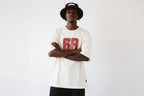 model front pose with crossed arms wearing oversized cream graphic t shirt streetwear fashion