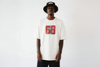 model front view wearing oversized cream graphic t shirt with varsity number print streetwear fashion