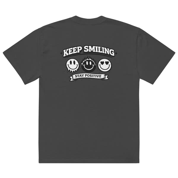 black t-shirt back view featuring large “KEEP SMILING – STAY POSITIVE” graphic with three vintage-style smiley faces in black, urban graphic design by Noiré.