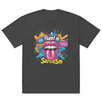 Oversized dark gray graphic t-shirt featuring colorful “Fluent in Sarcasm” print with bold pop art lips and tongue illustration.