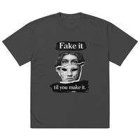 Black unisex t-shirt front view with illustrated face graphic and “Fake it til you make it” slogan, modern streetwear tee