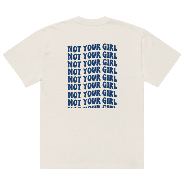 Oversized faded bone unisex t-shirt back view with repeated “Not Your Girl” blue typography print
