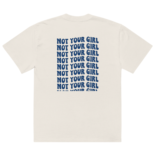 Oversized faded bone unisex t-shirt back view with repeated “Not Your Girl” blue typography print
