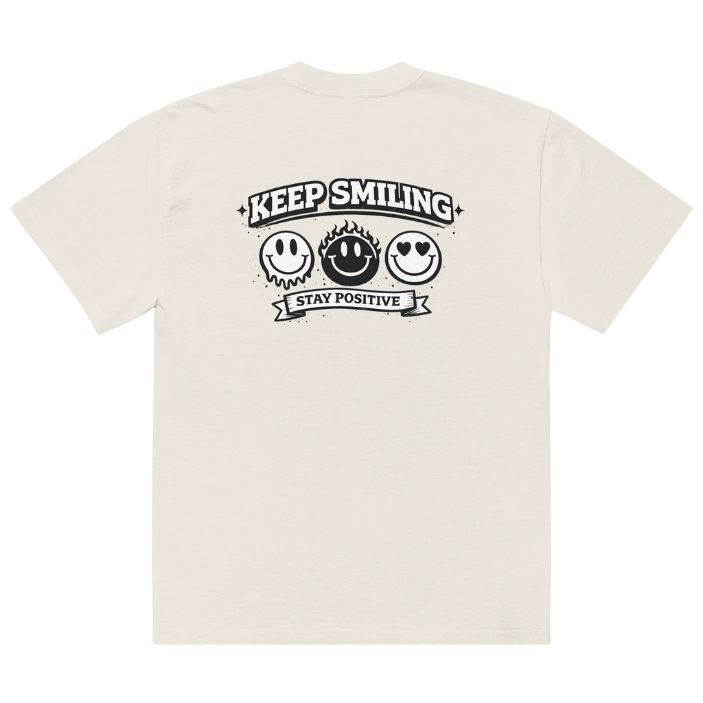 beige t-shirt back view featuring large “KEEP SMILING – STAY POSITIVE” graphic with three vintage-style smiley faces in black, urban graphic design by Noiré.