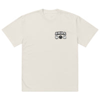 Beige t-shirt with small “SMILE” logo and minimalist smiley icons on the left chest, modern streetwear design by Noiré.
