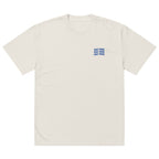 Front view of cream oversized women’s t-shirt with small navy “Just Mine” chest print, modern minimalist streetwear style.