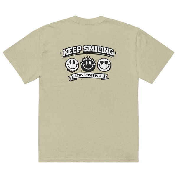 eucalyptus t-shirt back view featuring large “KEEP SMILING – STAY POSITIVE” graphic with three vintage-style smiley faces in black, urban graphic design by Noiré.
