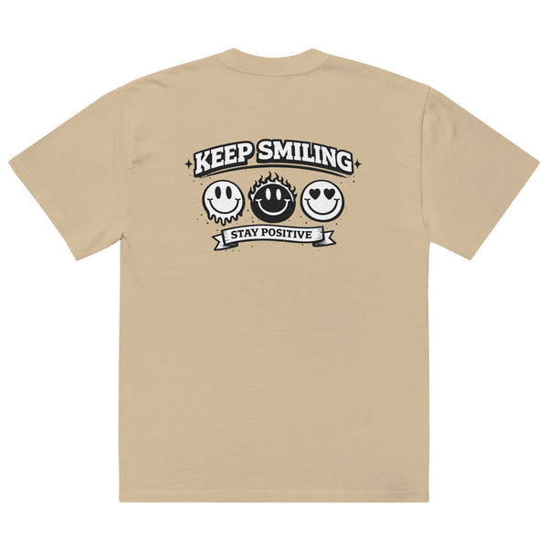  khaki t-shirt back view featuring large “KEEP SMILING – STAY POSITIVE” graphic with three vintage-style smiley faces in black, urban graphic design by Noiré.