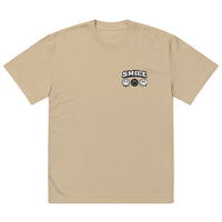 khaki t-shirt with small “SMILE” logo and minimalist smiley icons on the left chest, modern streetwear design by Noiré.