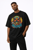 male model standing pose wearing oversized black graphic t shirt neon skull street graffiti design streetwear fashion