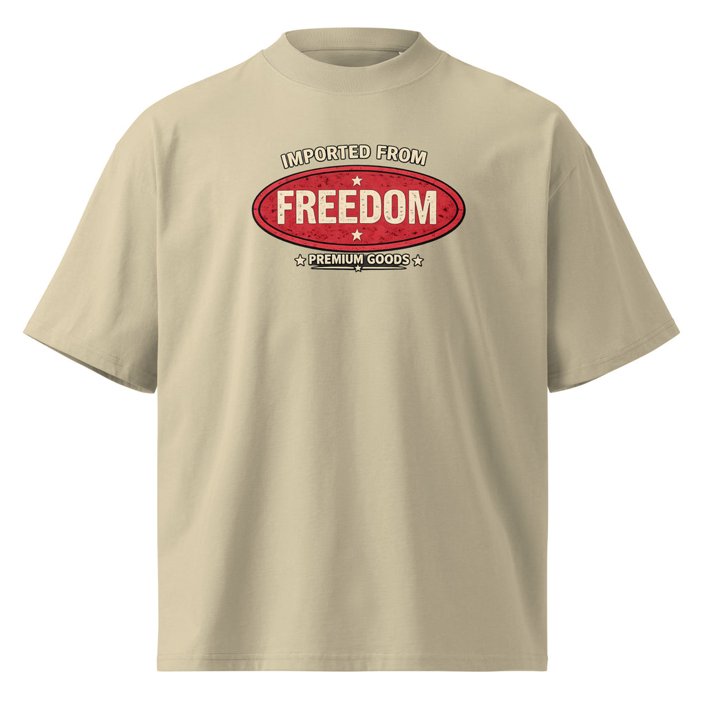 Beige graphic t-shirt front view with vintage red “Imported from Freedom – Premium Goods” chest logo, retro streetwear typography print, unisex casual tee.
