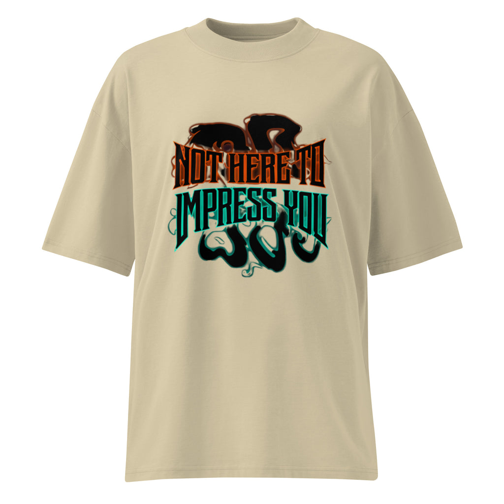 Beige oversized streetwear T-shirt featuring bold gothic “Not Here to Impress You” typography in orange and teal with subtle shadow graphic on the front