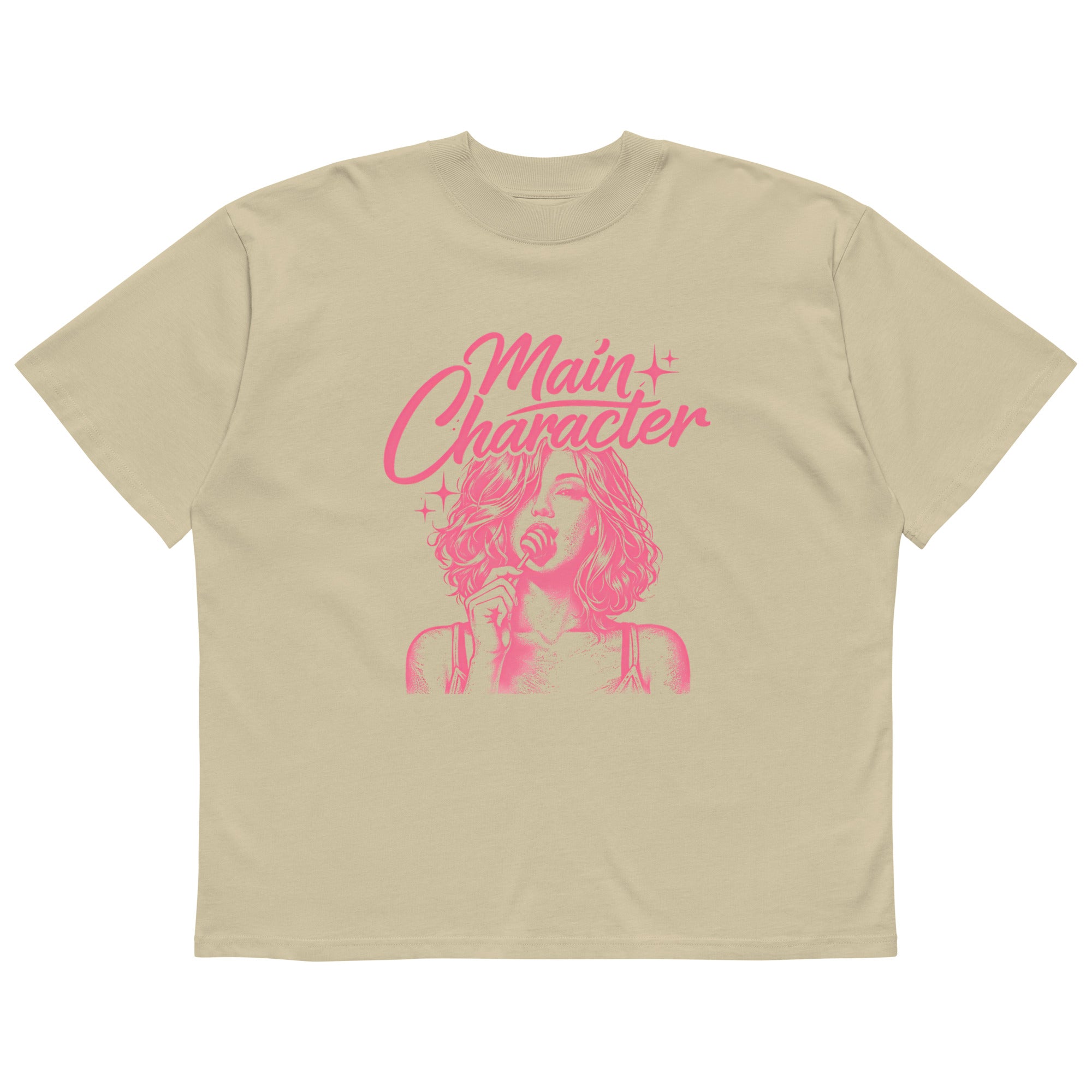 Sand beige women’s oversized t-shirt flat lay with bold pink “Main Character” statement graphic, contemporary women’s streetwear t-shirt product photo.