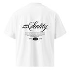 White oversized streetwear t-shirt back view with “Own Your Reality” script typography graphic print