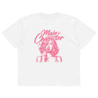 White women’s oversized t-shirt flat lay with pink “Main Character” typography and illustrated girl design, modern streetwear graphic tee product photo.