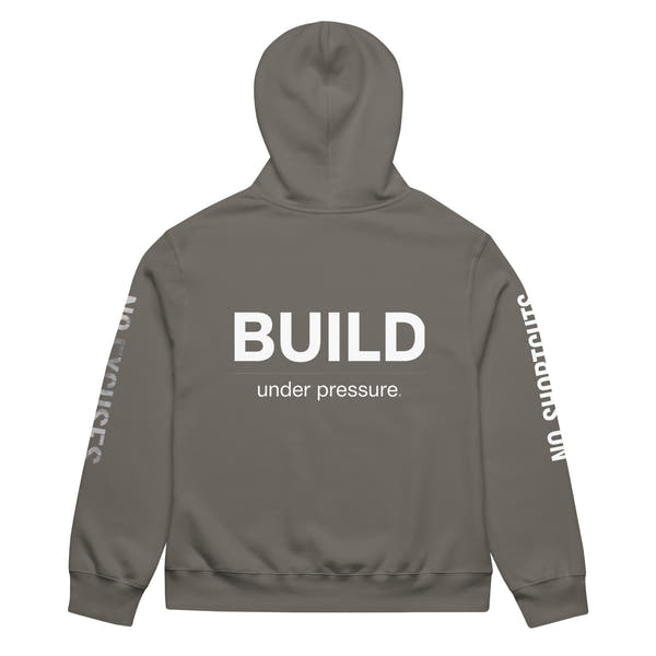 Asphalt unisex oversized hoodie with “Build Under Pressure” statement printed on back, streetwear hoodie back view.