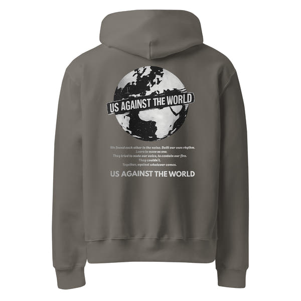 Grey unisex hoodie featuring “Us Against the World” world map graphic on the back, urban streetwear style