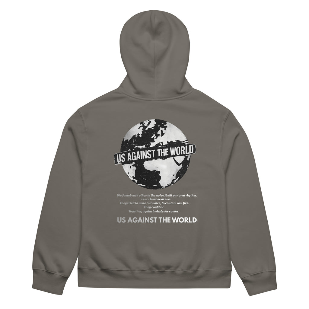 Grey unisex hoodie featuring “Us Against the World” world map graphic on the back, urban streetwear style