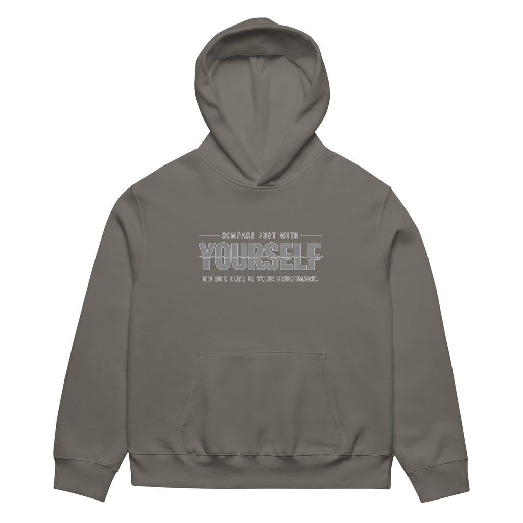 unisex streetwear hoodie front view with “compare just with yourself” motivational quote print
