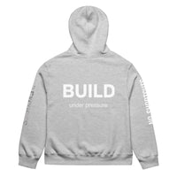 Athletic heather unisex oversized hoodie with “Build Under Pressure” statement printed on back, streetwear hoodie back view.