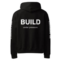 Black unisex oversized hoodie with “Build Under Pressure” statement printed on back, streetwear hoodie back view.