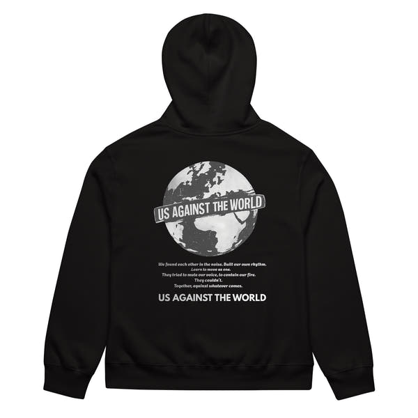 Black unisex hoodie with “Us Against the World” globe graphic print on the back, urban streetwear sweatshirt