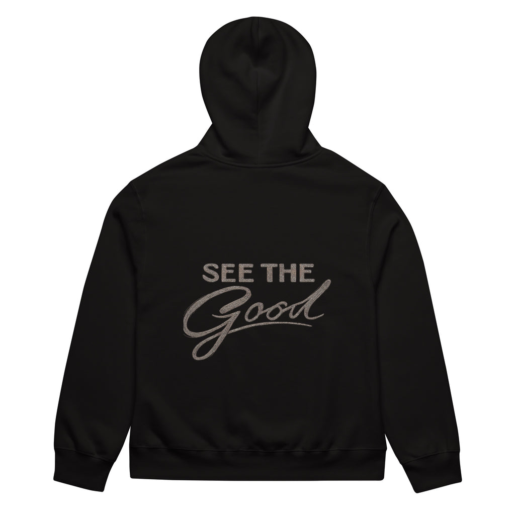 Black unisex streetwear hoodie back view with “See The Good” motivational typography print
