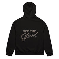 Black unisex streetwear hoodie back view with “See The Good” motivational typography print

