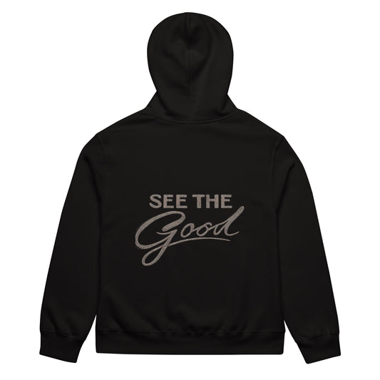 Black unisex streetwear hoodie back view with “See The Good” motivational typography print
