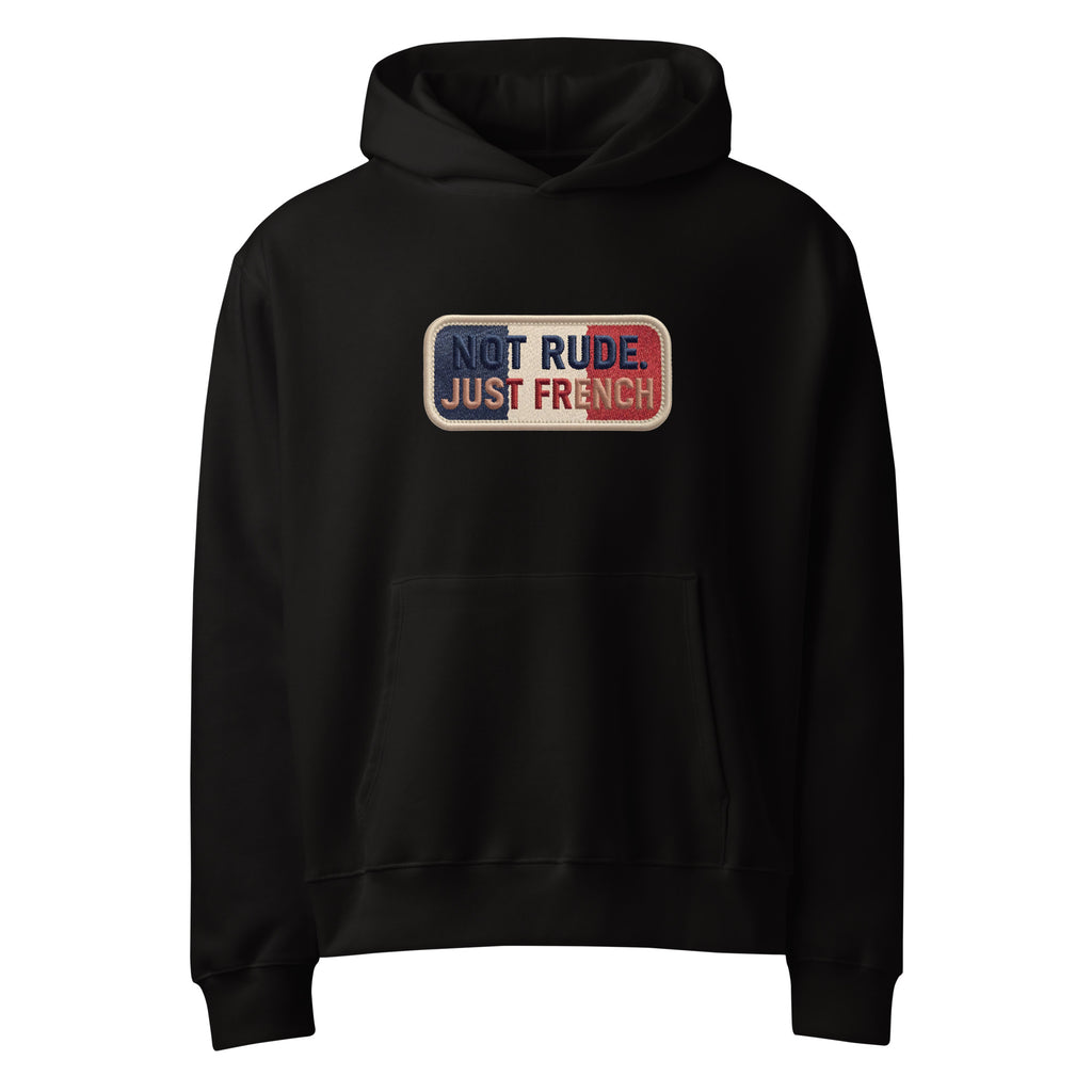 Black oversized hoodie with “Not Rude Just French” statement patch, front view
