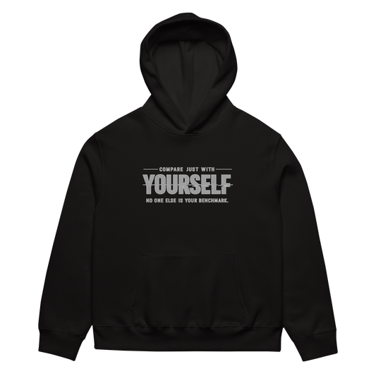 unisex streetwear hoodie front view with “compare just with yourself” motivational quote print
