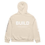 Beige hoodie featuring bold BUILD back print, rear view – modern statement hoodie by Noiré.