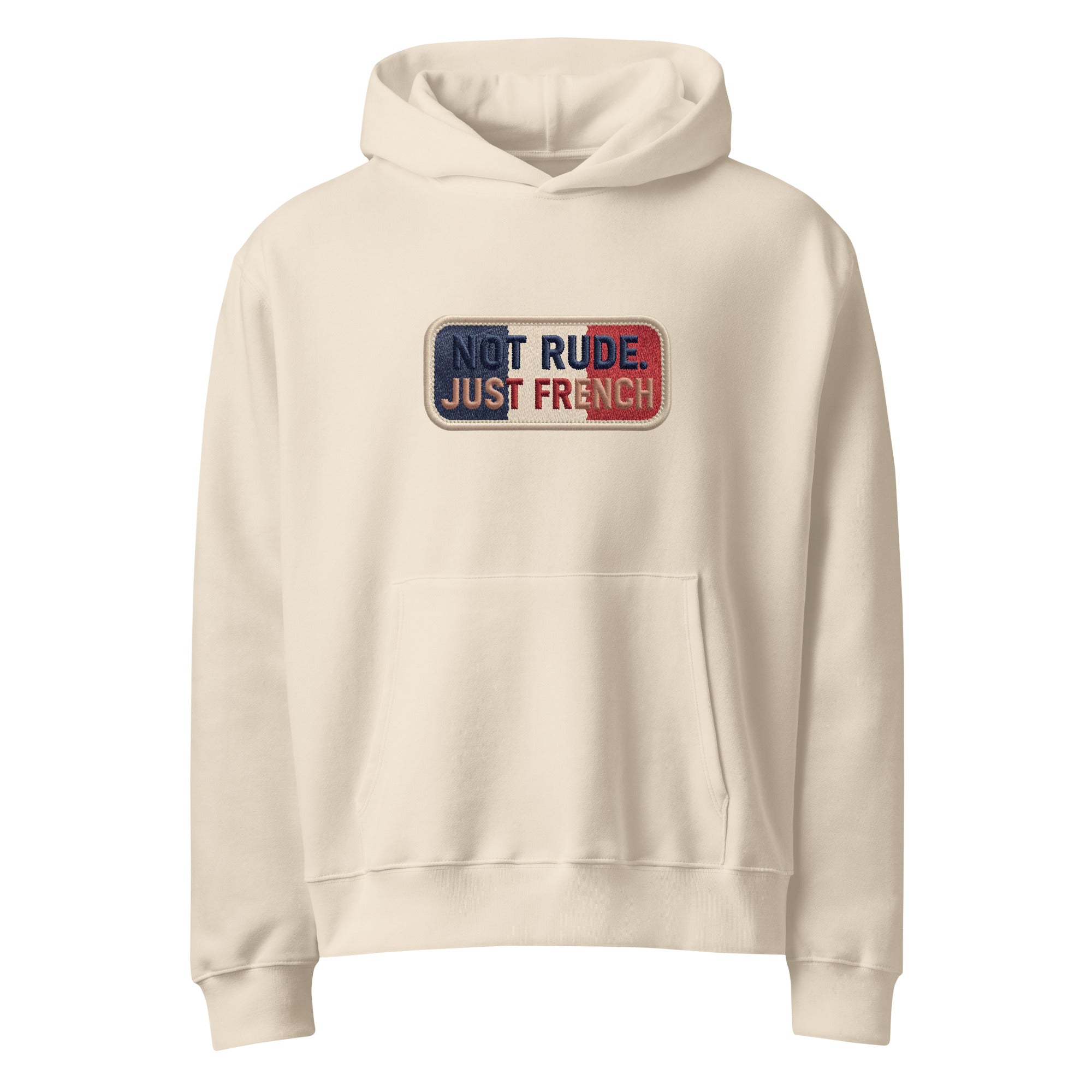 Beige oversized hoodie with “Not Rude Just French” statement patch, front view