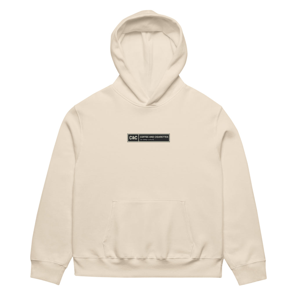 unisex streetwear hoodie front view with minimalist chest logo and coffee club typography design
