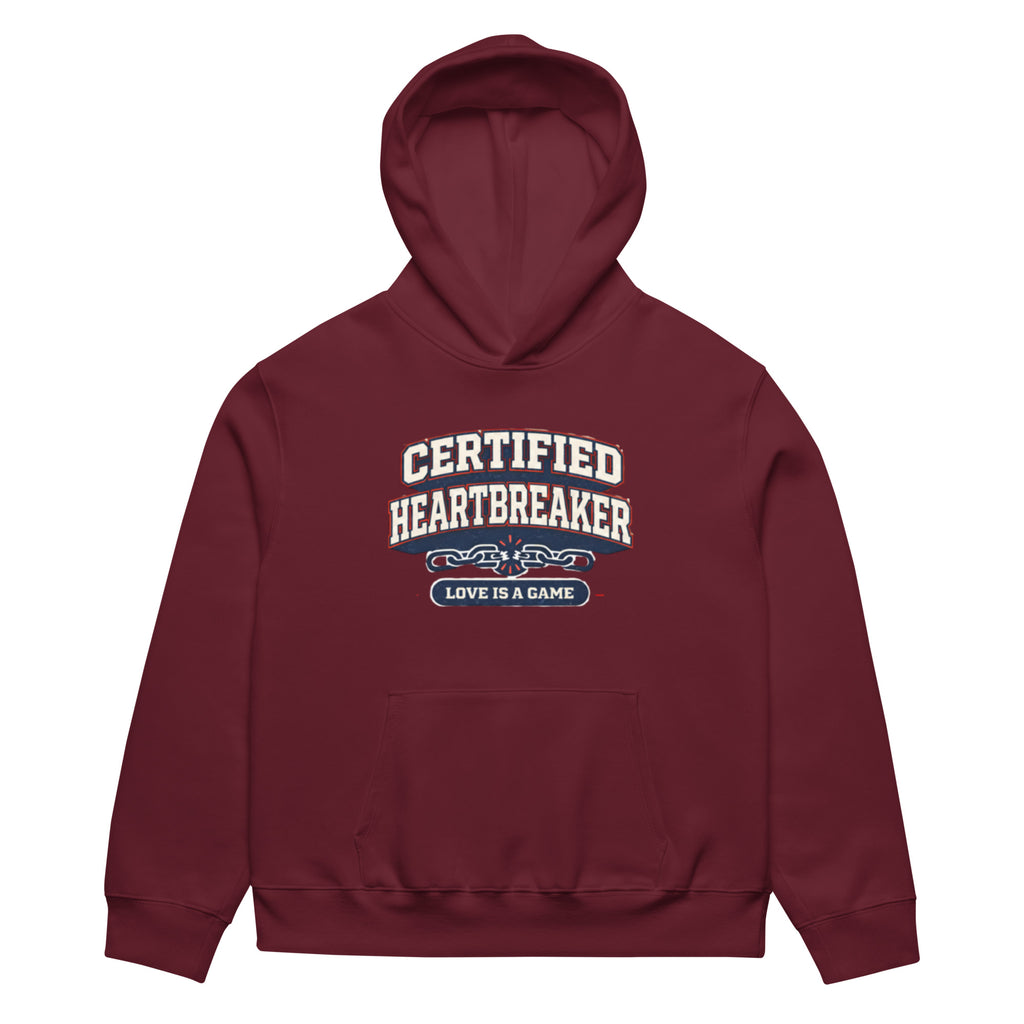 Maroon hoodie front view with “Certified Heartbreaker” varsity-style graphic and “Love Is a Game” slogan in red and navy collegiate typography.