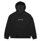 Front view of vintage black oversized streetwear hoodie with small “Leave Me Alone” chest text print, minimalist unisex casual sweatshirt