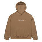 Front view of vintage brown oversized streetwear hoodie with small “Leave Me Alone” chest text print, minimalist unisex casual sweatshirt