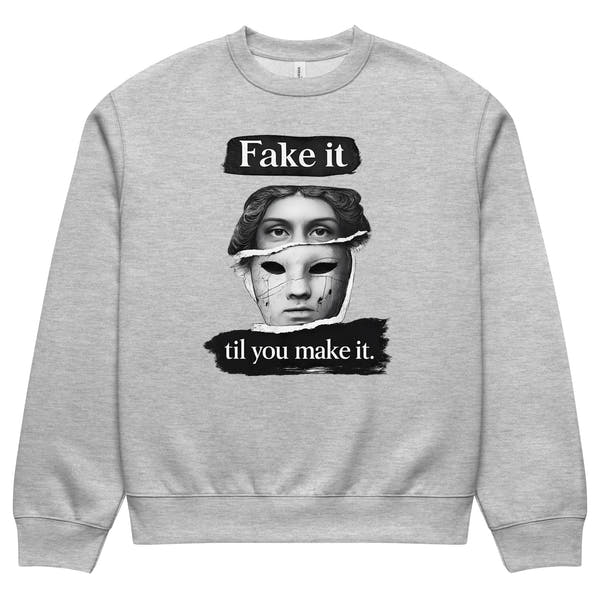 Grey unisex sweatshirt front view with graphic portrait design and “Fake it til you make it” typography, urban streetwear crewneck