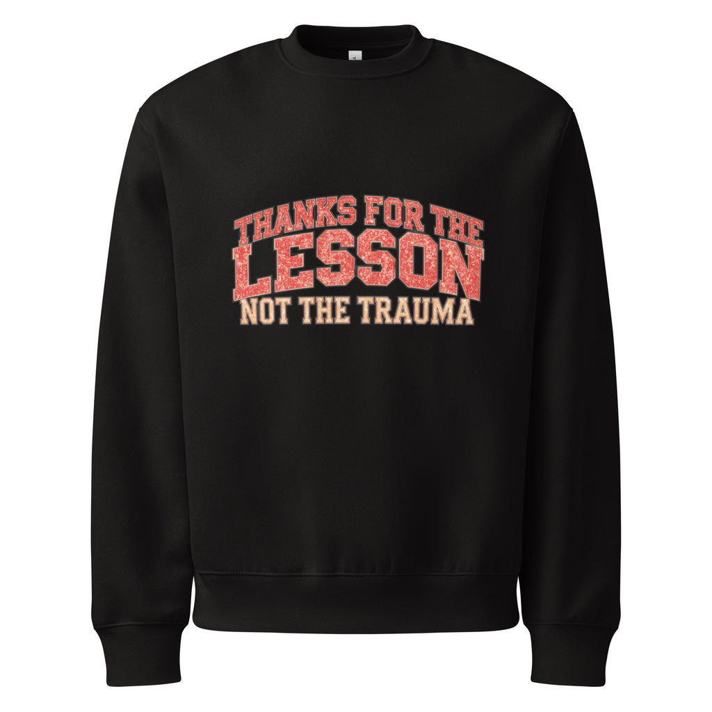 Black unisex sweatshirt front view with “Thanks for the Lesson, Not the Trauma” motivational typography print, modern streetwear pullover