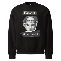 Black unisex sweatshirt front view with illustrated face graphic and “Fake it til you make it” slogan, modern streetwear crewneck