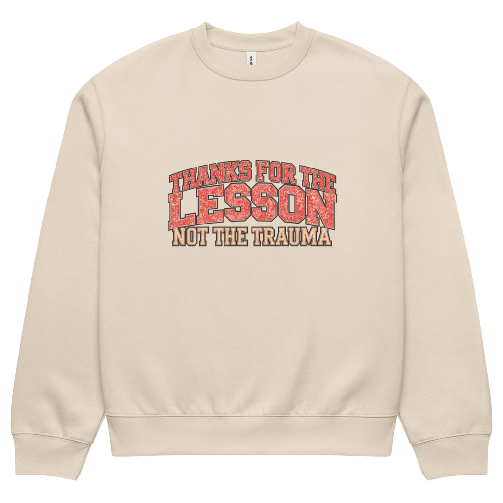 Beige unisex sweatshirt front view with “Thanks for the Lesson, Not the Trauma” motivational typography print, modern streetwear pullover
