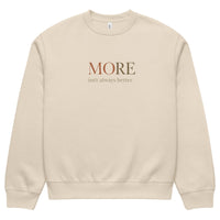 Beige oversized heavyweight sweatshirt featuring “MORE Isn’t Always Better” typography, minimalist streetwear design