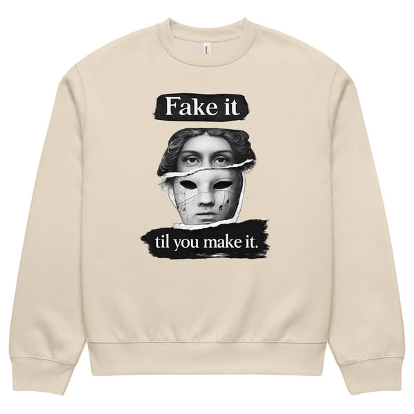 Beige unisex sweatshirt front view with bold illustrated face print and motivational slogan, contemporary streetwear style