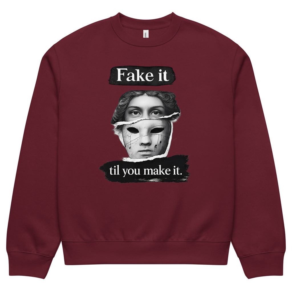 Burgundy unisex sweatshirt front view with illustrated face graphic and motivational text print, modern streetwear sweatshirt