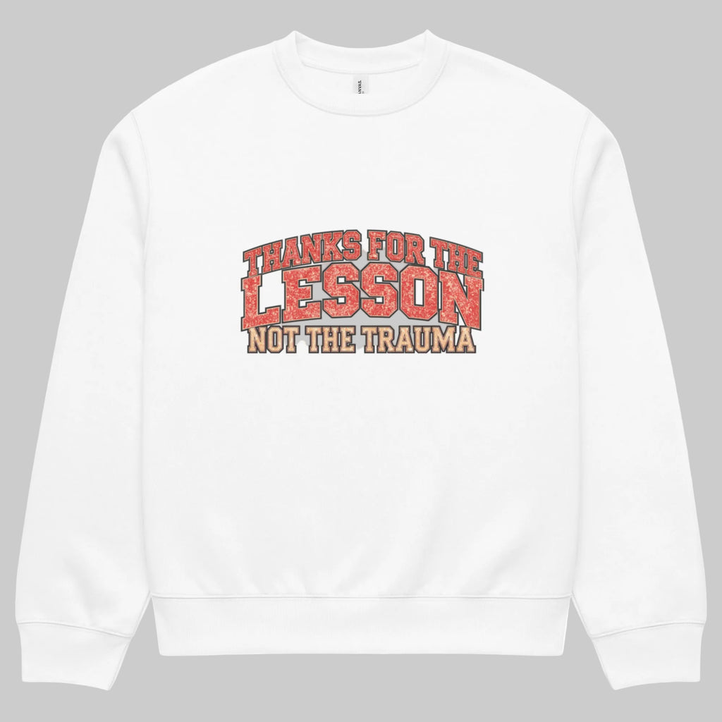 White unisex sweatshirt front view with “Thanks for the Lesson, Not the Trauma” motivational typography print, modern streetwear pullover